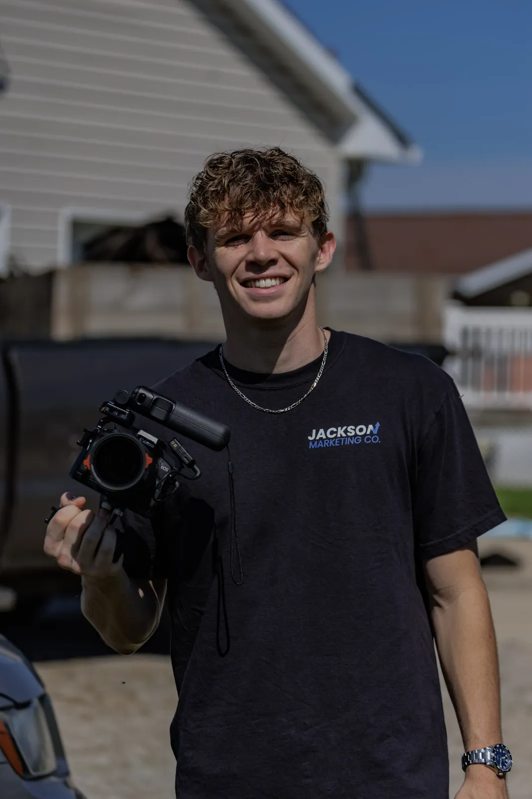 Brayden Jackson, founder of Jackson Marketing Co., holding a cinema camera on a client shoot in Ohio